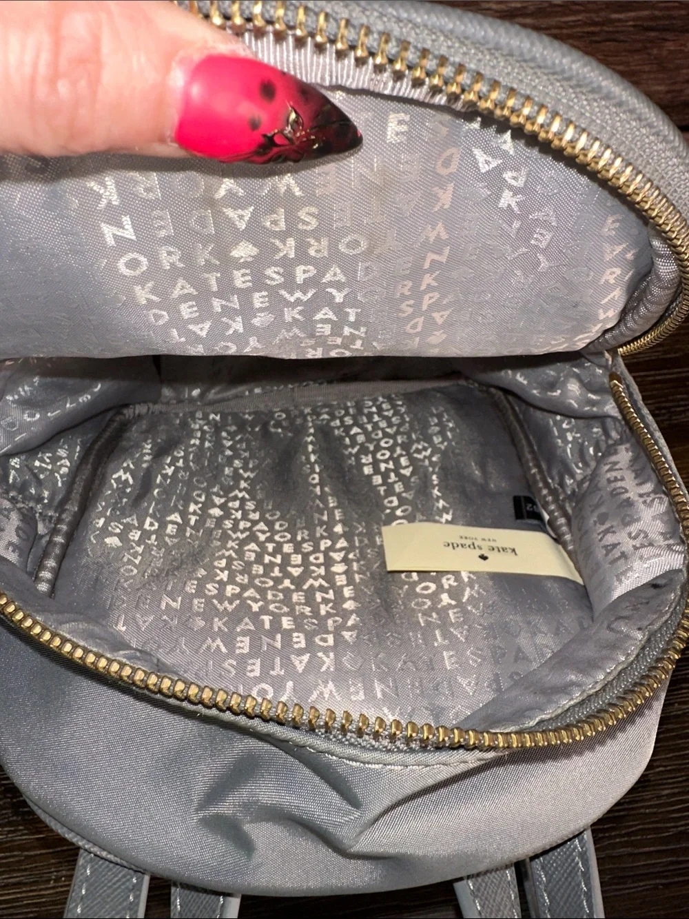 kate spade gray mini Bradley backpack with gold hardware